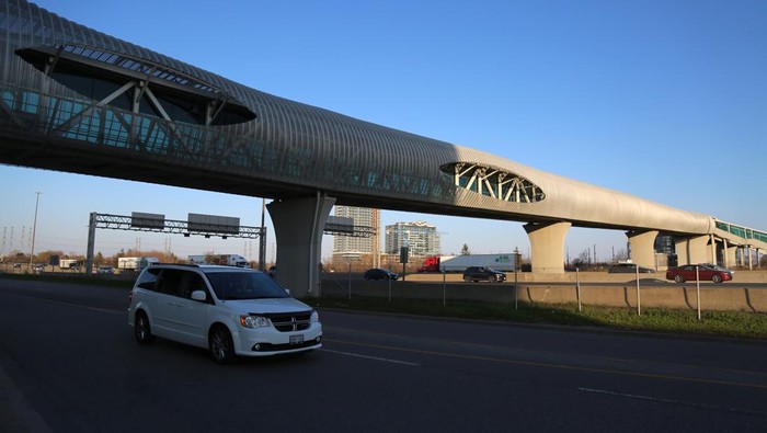 PICKERING, ONTARIO - APRIL 27 : Aerial view of cars and trucks pass under Pickering pedestrian bridge at night on Highway 401 in Pickering, Ontario on April 27, 2023. Guinness World Record holder Pickering pedestrian bridge, located 45 minutes east of Toronto, in the City of Pickering, Ontario, Canada was completed in September 2018. The 250-meter bridge stretches across 14 lanes of Highway 401, six active railway tracks, and a two-lane local road. Additionally, it features nearly 300 LED lights that illuminate it beautifully at night. (Photo by Mert Alper Dervis/Anadolu Agency via Getty Images)