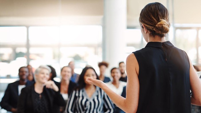 Shot of a young businesswoman delivering a speech during a conference