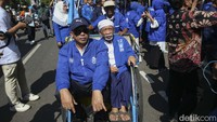 Komar hadir dengan menaiki becak.