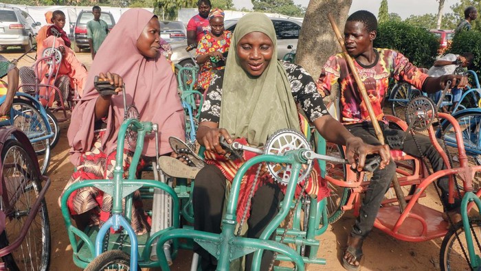 ABUJA, NIGERIA - MAY 11: Walking disabled people receive wheelchair bikes which are distributed within aid campaign organized under President-elect of Nigeria Bola Ahmed Tinubu in Abuja, Nigeria on May 11, 2023. (Photo by Emmanuel Osodi/Anadolu Agency via Getty Images)