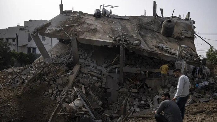 Palestinians inspect the rubble of a house after it was struck by an Israeli airstrike in Deir al-Balah, central Gaza Strip, Friday, May 12, 2023. (AP Photo/Fatima Shbair)