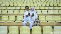 Pasangan Amin (25) dan Oci (21) asal Depok berpose dengan buku nikah usai sah menjadi suami istri.