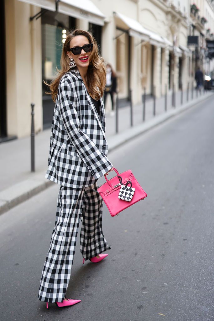 PARIS, FRANCE - APRIL 21: Alba Garavito Torre wears a baby blue and white striped print pattern puffy short sleeves / long dress from The Label Edition, gold bracelets, gold rings, a pale pink matte leather Capazo handbag from Saonara, during a street style fashion photo session, on April 21, 2023 in Paris, France. (Photo by Edward Berthelot/Getty Images)