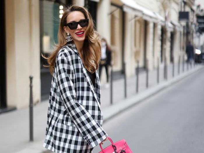 PARIS, FRANCE - APRIL 21: Alba Garavito Torre wears a baby blue and white striped print pattern puffy short sleeves / long dress from The Label Edition, gold bracelets, gold rings, a pale pink matte leather Capazo handbag from Saonara, during a street style fashion photo session, on April 21, 2023 in Paris, France. (Photo by Edward Berthelot/Getty Images)