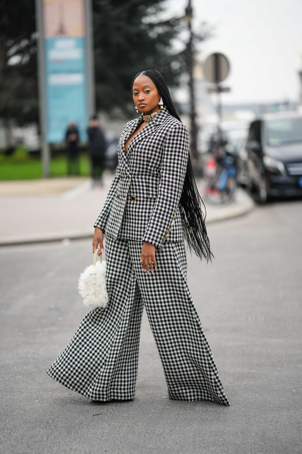 PARIS, FRANCE - APRIL 21: Alba Garavito Torre wears a baby blue and white striped print pattern puffy short sleeves / long dress from The Label Edition, gold bracelets, gold rings, a pale pink matte leather Capazo handbag from Saonara, during a street style fashion photo session, on April 21, 2023 in Paris, France. (Photo by Edward Berthelot/Getty Images)