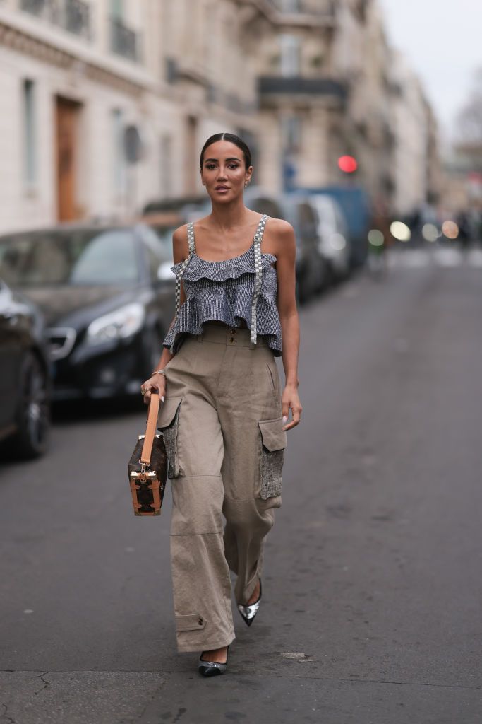 PARIS, FRANCE - APRIL 21: Alba Garavito Torre wears a baby blue and white striped print pattern puffy short sleeves / long dress from The Label Edition, gold bracelets, gold rings, a pale pink matte leather Capazo handbag from Saonara, during a street style fashion photo session, on April 21, 2023 in Paris, France. (Photo by Edward Berthelot/Getty Images)