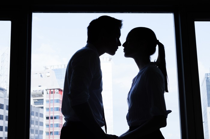 Business couple kissing in the office. Business affair.