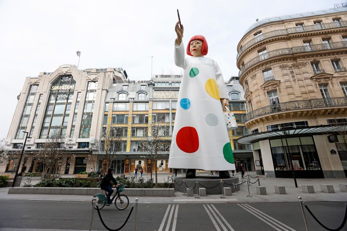 PARIS, FRANCE - MARCH 06: A huge sculpture in the likeness of Yayoi Kusama is erected between the headquarters of the Maison Louis Vuitton and the Samaritaine department store on March 06, 2023 in Paris, France. A free, masterful and surprising installation in honor of Louis Vuitton's new collaboration with the famous designer. Yayoi Kusama is an avant-garde Japanese contemporary artist, painter, sculptor and writer who often uses polka dots and colors in her works. (Photo by Chesnot/Getty Images)