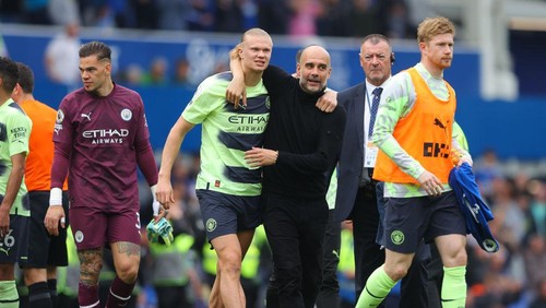 LIVERPOOL, ENGLAND - MAY 14: Josep Pep Guardiola, manager of Manchester City, celebrates with Erling Haaland of Manchester City during the Premier League match between Everton FC and Manchester City at Goodison Park on May 14, 2023 in Liverpool, England. (Photo by James Gill - Danehouse/Getty Images)