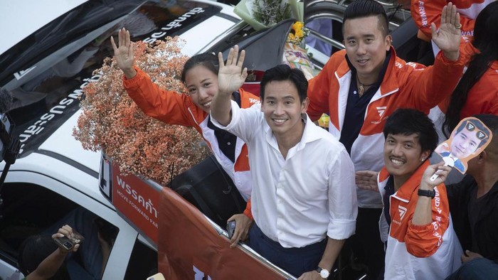 Pita Limjaroenrat, center, (white shirt) leader of Move Forward Party, waves to his supporters in Bangkok Monday, May 15, 2023. Fresh off a stunning election victory in which they together captured a majority of seats in the House of Representatives, Thailands top two opposition parties began planning Monday for the next stage in their bid to replace the military-dominated government. (AP Photo/Wason Wanichakorn)