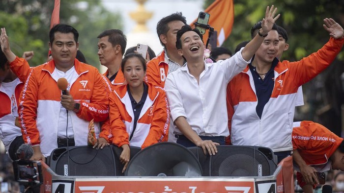 Pita Limjaroenrat, center, (white shirt) leader of Move Forward Party, waves to his supporters in Bangkok Monday, May 15, 2023. Fresh off a stunning election victory in which they together captured a majority of seats in the House of Representatives, Thailands top two opposition parties began planning Monday for the next stage in their bid to replace the military-dominated government. (AP Photo/Wason Wanichakorn)