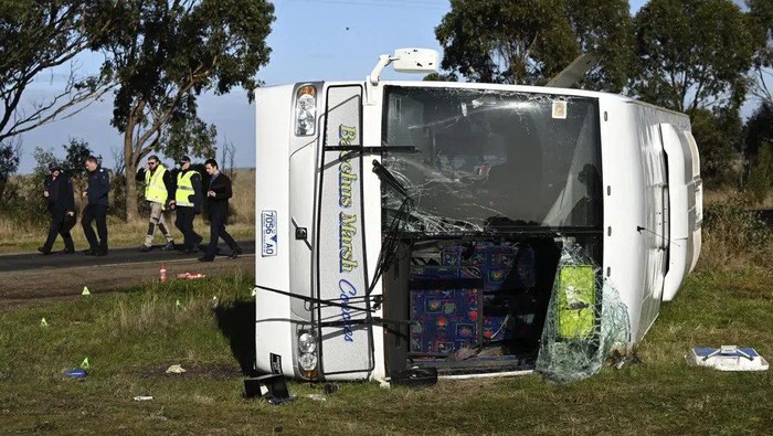 Investigators work at the scene of a bus crash near in Melbourne, Wednesday, May 17, 2023. Seven children remain hospitalized with serious injuries after a truck struck a school bus Tuesday carrying as many as 45 students on the outskirts of Melbourne in southeastern Australia. (Joel Carrett/AAP Image via AP)