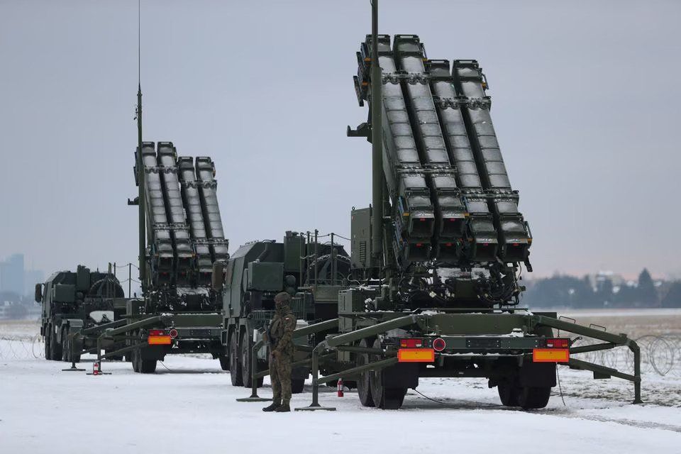 Serviceman patrols in front of the Patriot air defence system during Polish military training on the missile systems at the airport in Warsaw, Poland February 7, 2023. REUTERS/Kacper Pempel
