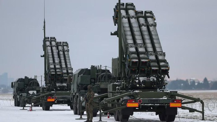 Serviceman patrols in front of the Patriot air defence system during Polish military training on the missile systems at the airport in Warsaw, Poland February 7, 2023. REUTERS/Kacper Pempel