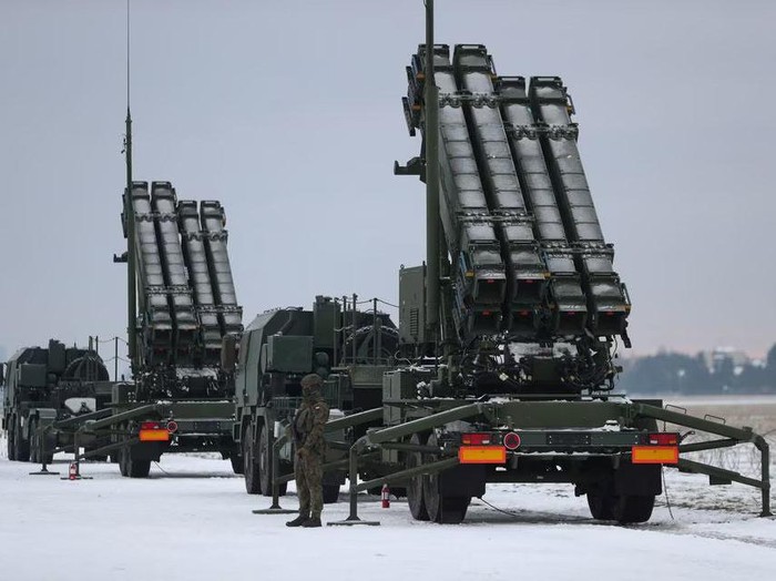 Serviceman patrols in front of the Patriot air defence system during Polish military training on the missile systems at the airport in Warsaw, Poland February 7, 2023. REUTERS/Kacper Pempel