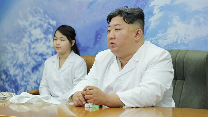 North Korean leader Kim Jong Un and his daughter Kim Ju Ae meet with members of the Non-permanent Satellite Launch Preparatory Committee, as he inspects the countrys first military reconnaissance satellite, in Pyongyang, North Korea May 16, 2023, in this image released by North Koreas Korean Central News Agency on May 17, 2023. KCNA via REUTERS ATTENTION EDITORS - THIS IMAGE WAS PROVIDED BY A THIRD PARTY. REUTERS IS UNABLE TO INDEPENDENTLY VERIFY THIS IMAGE. NO THIRD PARTY SALES. SOUTH KOREA OUT. NO COMMERCIAL OR EDITORIAL SALES IN SOUTH KOREA.