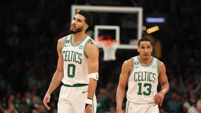 BOSTON, MASSACHUSETTS - MAY 17: Jayson Tatum #0 and Malcolm Brogdon #13 of the Boston Celtics walk backcourt during the fourth quarter of game one of the Eastern Conference Finals against the Miami Heat at TD Garden on May 17, 2023 in Boston, Massachusetts. NOTE TO USER: User expressly acknowledges and agrees that, by downloading and or using this photograph, User is consenting to the terms and conditions of the Getty Images License Agreement. (Photo by Adam Glanzman/Getty Images)