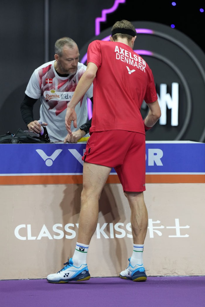 SUZHOU, CHINA - MAY 19: Denmark's Viktor Axelsen receives treatment during the men's singles quarter-final match against Malaysia's Lee Zii Jia at the 2023 Sudirman Cup world badminton championships in Suzhou in China's eastern Jiangsu province on May 19, 2023. (Photo by Fred Lee/Getty Images)