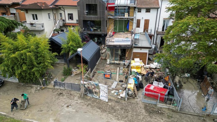 Residents remove debris after heavy rains hit Italy's Emilia Romagna region, in Cesena, Italy, May 18, 2023. REUTERS/Antonio Denti