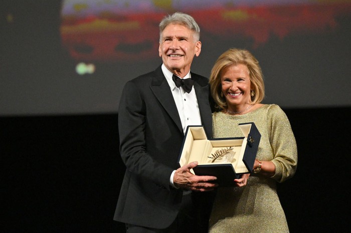 Harrison Ford CANNES, FRANCE - MAY 18: Harrison Ford receives an honorary Palme D'Or from Iris Knobloch during the 76th annual Cannes film festival at Palais des Festivals on May 18, 2023 in Cannes, France. (Photo by Stephane Cardinale - Corbis/Corbis via Getty Images)