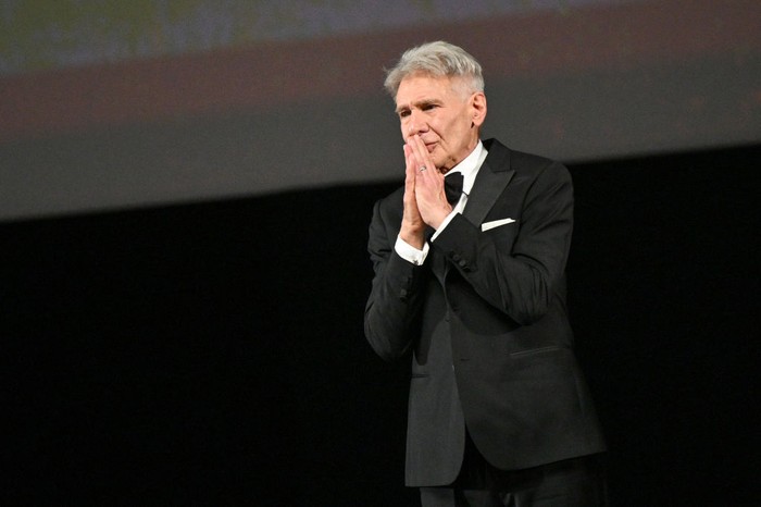 CANNES, FRANCE - MAY 18: Harrison Ford receives an honorary Palme D'Or from Iris Knobloch during the 76th annual Cannes film festival at Palais des Festivals on May 18, 2023 in Cannes, France. (Photo by Stephane Cardinale - Corbis/Corbis via Getty Images)