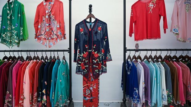 This picture taken on April 7, 2023 shows kebayas, a traditional outfit worn by women in Southeast Asia, displayed for sale at a shop in Kuala Lumpur. - Brunei, Indonesia, Malaysia, Singapore and Thailand agreed to jointly nominate the 