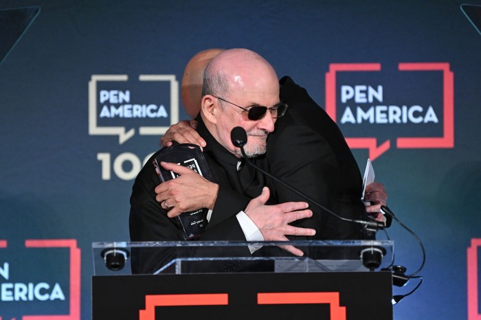 NEW YORK, NEW YORK - MAY 18: Honoree Salman Rushdie and Ayad Akhtar appear on stage at the 2023 PEN America Literary Gala at American Museum of Natural History on May 18, 2023 in New York City. (Photo by Bryan Bedder/Getty Images for PEN America)