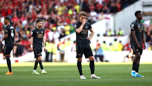 Arsenals Norwegian midfielder Martin Odegaard (2R) reacts during the English Premier League football match between Nottingham Forest and Arsenal at The City Ground in Nottingham, central England, on May 20, 2023. (Photo by DARREN STAPLES / AFP) / RESTRICTED TO EDITORIAL USE. No use with unauthorized audio, video, data, fixture lists, club/league logos or live services. Online in-match use limited to 120 images. An additional 40 images may be used in extra time. No video emulation. Social media in-match use limited to 120 images. An additional 40 images may be used in extra time. No use in betting publications, games or single club/league/player publications. /  (Photo by DARREN STAPLES/AFP via Getty Images)