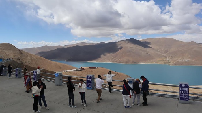 Birunya Danau Suci Yamdrok di Puncak Pegunungan Tibet Para pengunjung mengabadikan pemandangan Danau Yamdrok, Daerah Otonomi Tibet, China, Minggu (21/5/2023). Danau sepanjang 72 kilometer di atas ketingian 5.000 meter dari permukaan laut tersebut merupakan salah satu dari tiga danau suci masyarakat Buddha Tibet. (ANTARA FOTO/M. Irfan Ilmie)