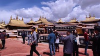 Sejumlah wisatawan berpose di bangunan tertinggi Istana Potala yang dikenal sebagai ikon Kota Lasha.  