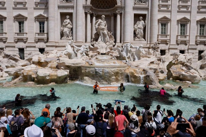 Climate activists pour vegetable charcoal in the Trevi Fountain water, during a demonstration against fossil fuels, in Rome, Italy May 21, 2023 in this image obtained from social media.  Alessandro Penso/MAPS via REUTERS  THIS IMAGE HAS BEEN SUPPLIED BY A THIRD PARTY. MANDATORY CREDIT. NO RESALES. NO ARCHIVES.
