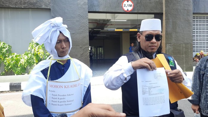 Tersangka pencabulan anak di bawah umur, Rian Antoni pakai seragam pocong di jalanan dan Polda Sumsel. (Foto. Prima Syahbana)