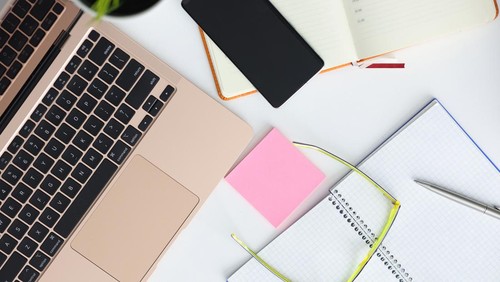 On table laptop smartphone glasses pen and notepad. Online courses for freelancers concept