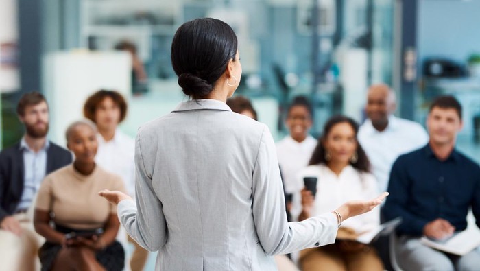 Rearview shot of an unrecognizable businesswoman giving a presentation in the office boardroom