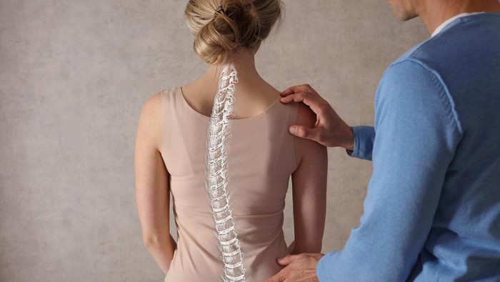 Woman suffering from back ache on the bed, healthcare and problem concept