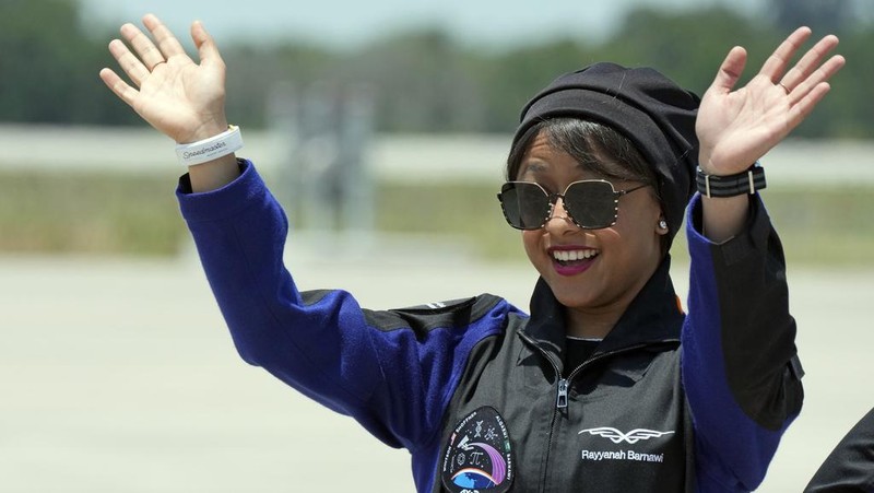 Saudi Arabian astronaut Rayyanah Barnawi waves to family and friends as she arrives at the Kennedy Space Center in Cape Canaveral, Fla., for a scheduled launch Sunday, May 21, 2023. (AP Photo/John Raoux)