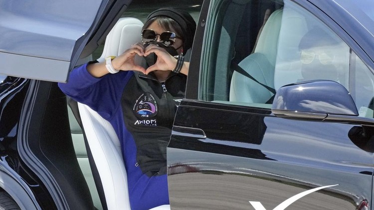Saudi Arabian astronaut Rayyanah Barnawi waves to family and friends as she arrives at the Kennedy Space Center in Cape Canaveral, Fla., for a scheduled launch Sunday, May 21, 2023. (AP Photo/John Raoux)