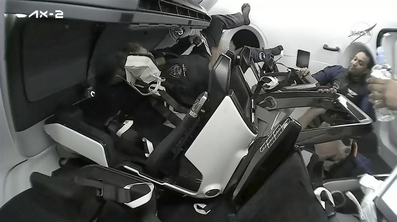 In this image from NASA TV, Ali al-Qarni, second from left, and Rayyanah Barnawi of Saudi Arabia, second right, have a drink alongside two cosmonauts in the International Space Station, Monday, May 22, 2023. The space station rolled out the welcome mat for the two Saudi visitors, including the kingdom's first female astronaut. (NASA TV via AP)