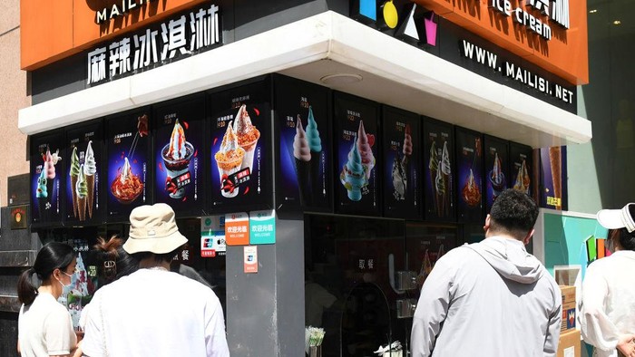 CHONGQING, CHINA - MAY 24: People queue up to buy spicy ice cream at Jiefangbei area on May 24, 2023 in Chongqing, China. A shop located on the Jiefangbei area promoted spicy-flavor ice cream, attracting many citizens to have a taste. (Photo by Zhou Yi/China News Service/VCG via Getty Images)