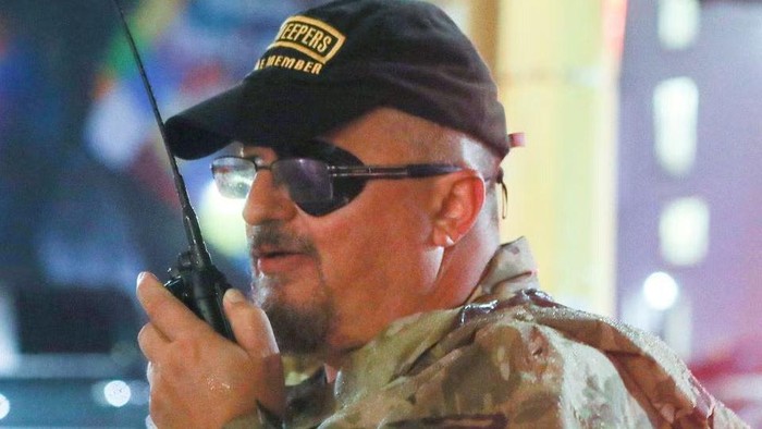 Oath Keepers militia founder Stewart Rhodes uses a radio as he departs with volunteers from a rally held by U.S. President Donald Trump in Minneapolis, Minnesota, U.S. October 10, 2019. Picture taken October 10, 2019. REUTERS/Jim Urquhart