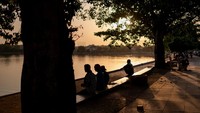 Para warga duduk santai di pinggir kolam di raipur, Chhattisgarh, India.