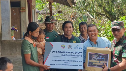Dandim 1611/Badung Letkol Arh Teguh Waluyo memberikan nutrisi tambahan kepada sebuah keluarga yang memiliki anak perempuan stunting Ni Kadek Aprilia Nita Sari (2) di Baler Pasar, Badung, Sabtu (27/5/2023). (Ronatal Siahaan/detikBali)