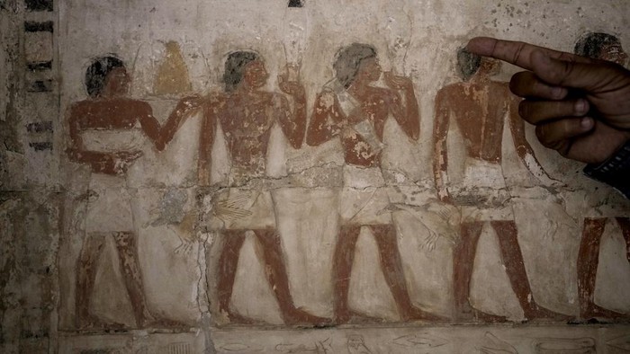 Mostafa Waziri, secretary-general of the Supreme Council of Antiquities, displays a recently unearthed ancient wooden sarcophagus at the site of the Step Pyramid of Djoser in Saqqara, 24 kilometers (15 miles) southwest of Cairo, Egypt, Saturday, May 27, 2023. Saqqara is a part of Egypt's ancient capital of Memphis, a UNESCO World Heritage site. Waziri said the workshops had been used to mummify humans and sacred animals, dated back to the 30th Pharaonic Dynasty 380 BC to 343 BC and Ptolemaic period 305 BC to 30 BC. (AP Photo/Amr Nabil)