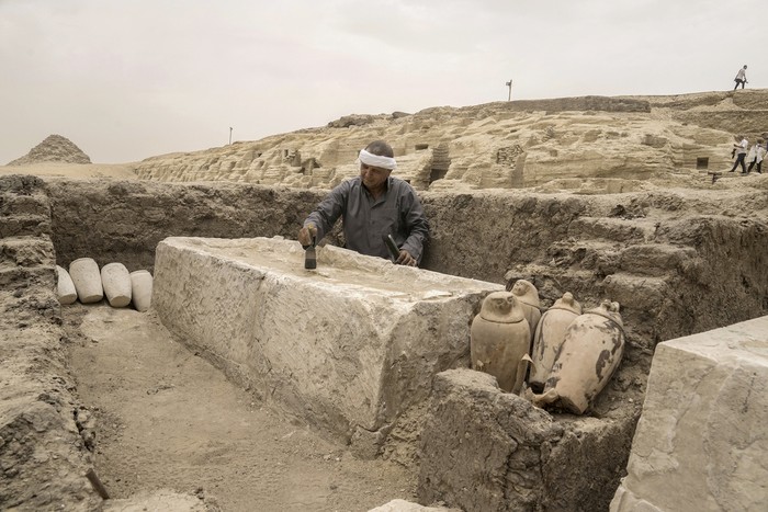 Mostafa Waziri, secretary-general of the Supreme Council of Antiquities, displays a recently unearthed ancient wooden sarcophagus at the site of the Step Pyramid of Djoser in Saqqara, 24 kilometers (15 miles) southwest of Cairo, Egypt, Saturday, May 27, 2023. Saqqara is a part of Egypts ancient capital of Memphis, a UNESCO World Heritage site. Waziri said the workshops had been used to mummify humans and sacred animals, dated back to the 30th Pharaonic Dynasty 380 BC to 343 BC and Ptolemaic period 305 BC to 30 BC. (AP Photo/Amr Nabil)