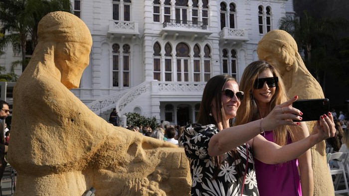 A crowd of people gather at the courtyard of the Sursock Museum during an opening event for the iconic venue in Beirut, Lebanon, Friday, May 26, 2023. The museum has reopened to the public, three years after after a deadly explosion in the nearby Beirut port reduced many of its treasured paintings and collections to ashes. (AP Photo/Hussein Malla)