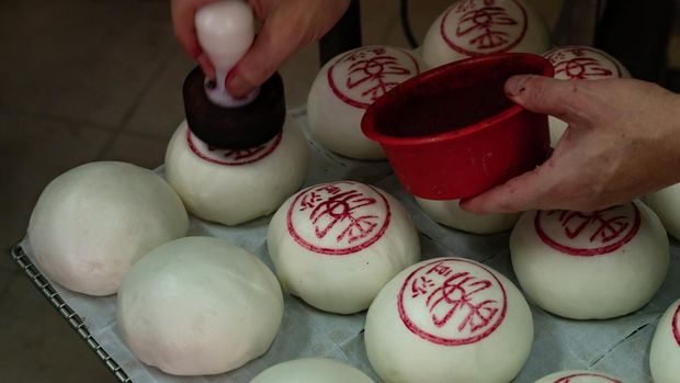 Pedagang meembuat Bakpao yang di hias berlangsungnya Bakpao di pulau Cheung Chau, Hong Kong. (Getty Images/Anthony Kwan)