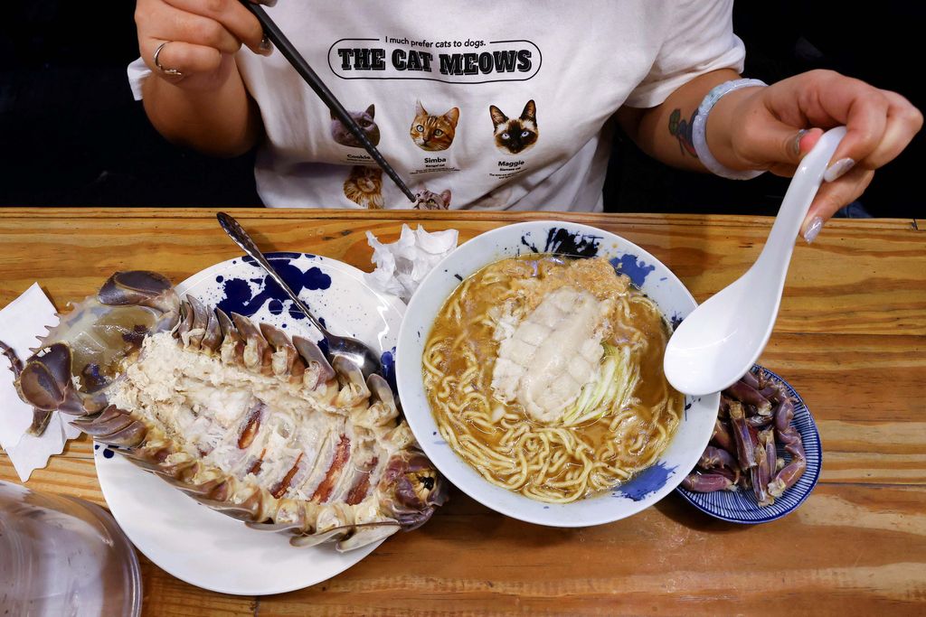 General Kiang, 28, one of the two reserved customers eats the giant isopod in Taipei, Taiwan May 27, 2023. REUTERS/Ann Wang