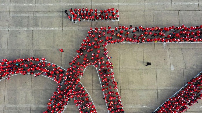 1258218924 Aerial view of thousands of cyclists in the shape of a bicycle trying to break the Guinness World Record for the world's largest bicycle, in the framework of the Bicycle Festival, in Santiago on May 27, 2023. (Photo by MARTIN BERNETTI / AFP) (Photo by MARTIN BERNETTI/AFP via Getty Images)