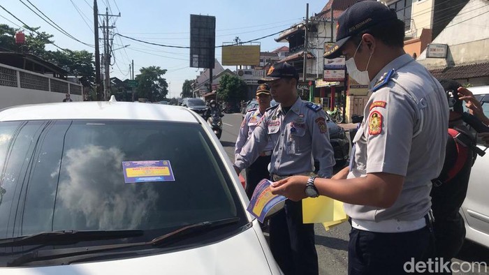 Petugas gabungan melakukan penertiban parkir di Jalan Pasar Kembang, Kota Jogja, Selasa (30/5/2023).