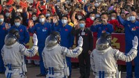 Attendees wave goodbye to Chinese astronauts during a send-off ceremony for their manned space mission at the Jiuquan Satellite Launch Center in northwestern China, Tuesday, May 30, 2023. (AP Photo/Mark Schiefelbein)